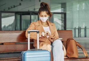 A young and beautiful girl is waiting for flight for safe travels.